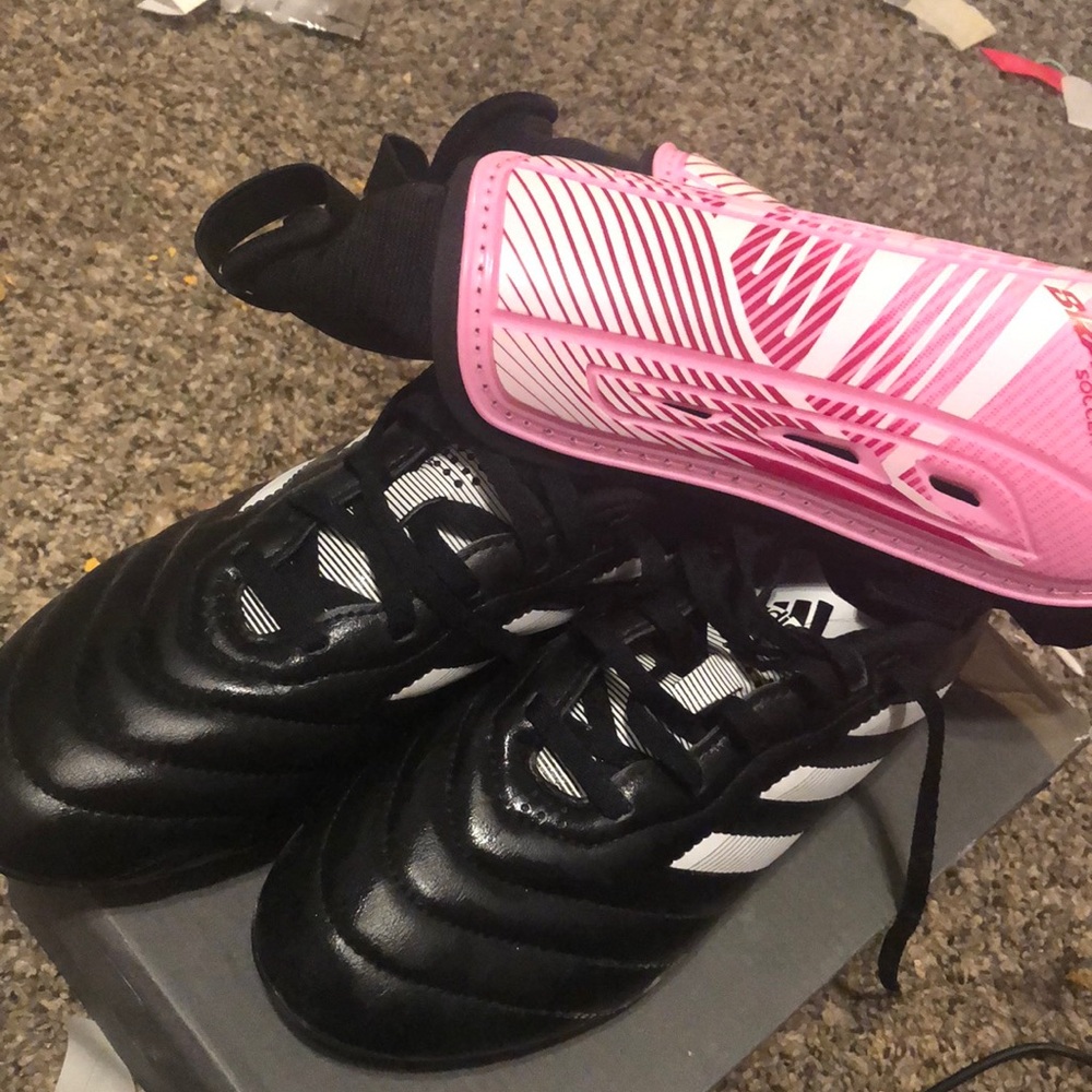 Never used female soccer cleats with medium shin guards adidas black